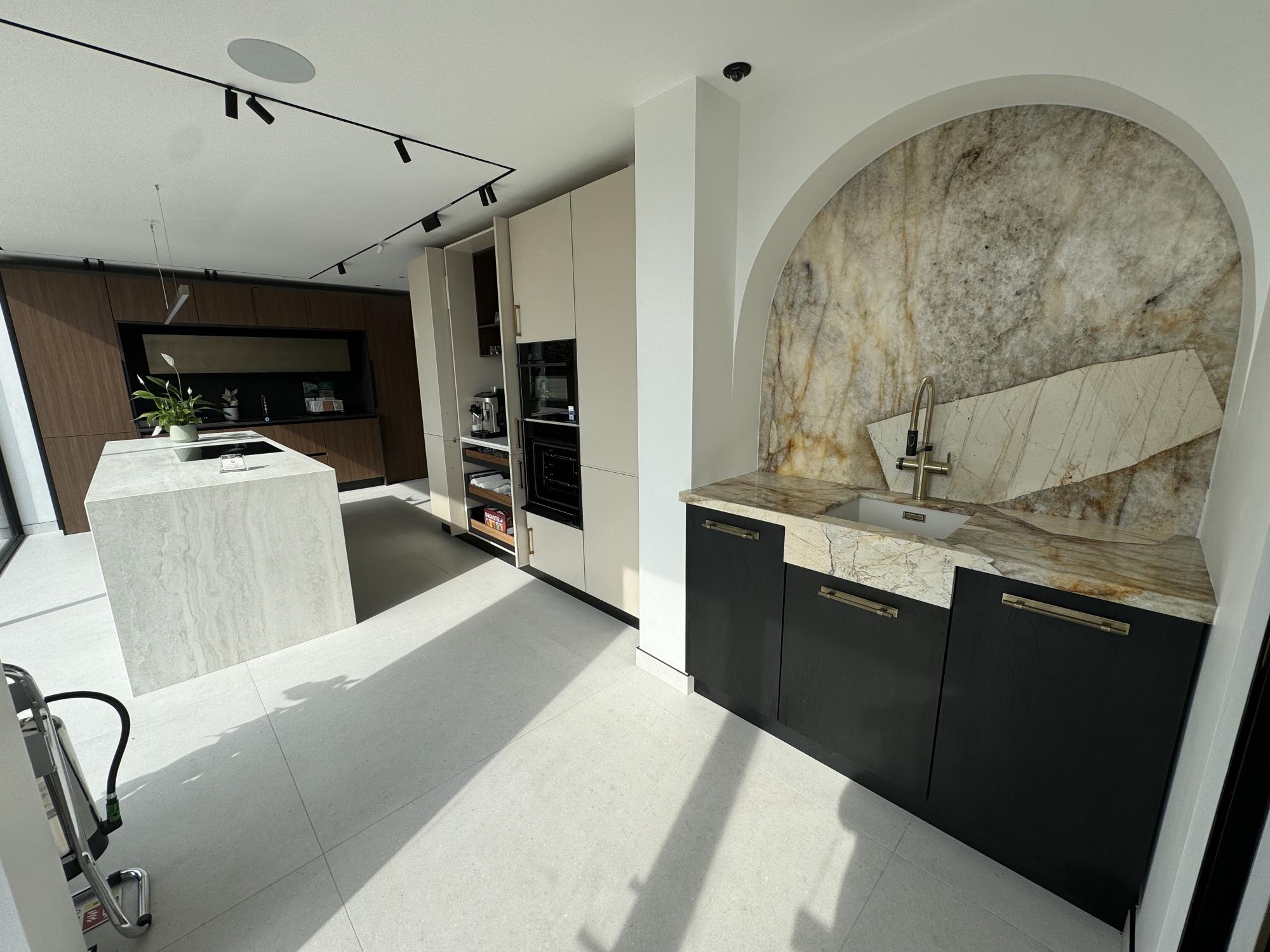 Bright and modern kitchen with big sink and marble tabletop